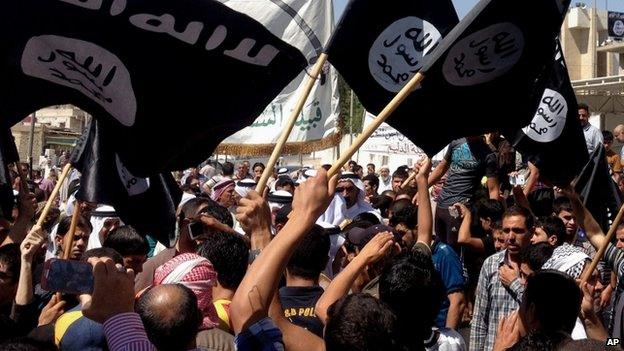 ISIS supporters demonstrate in front of the provincial government headquarters in Mosul, 360km (225 miles) north-west of Baghdad