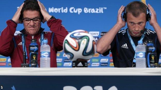 Fabio Capello, Italian coach of Russia, and defender Vasily Berezutsky arrive for a news conference on 16 June