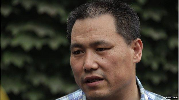 Chinese human rights lawyer Pu Zhiqiang talks to media in Beijing in this 20 July 2012 picture.