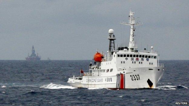 A Chinese Coast Guard vessel passes near the Chinese oil rig, Haiyang Shi You 981 in the South China Sea on 13 June 2014.