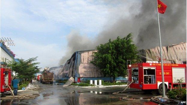 This photo taken on 14 May2014 shows smoke billowing from a Taiwanese furniture factory in Binh Duong, southern Vietnam as anti-China protesters set factories on fire.