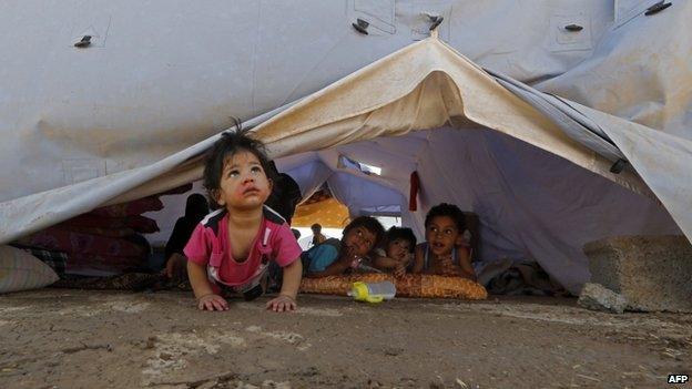 Displaced Iraqi children inside a UNHRC tent at a temporary camp near Arbil (17 June 2014)