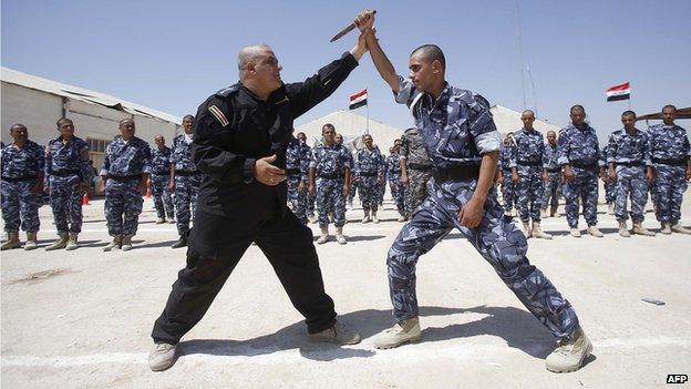 Newly-recruited Iraqi volunteers, wearing police forces uniforms, take part in a training session on June 17