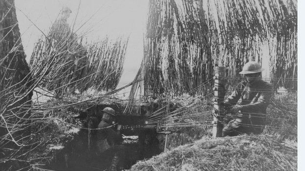 A field radio station, camouflaged with brush-wood and straw, in around 1918