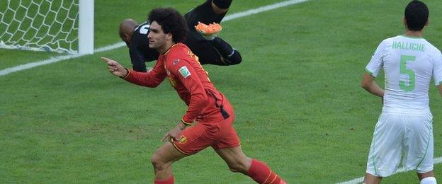 Belgium's midfielder Marouane Fellaini (front left) celebrates after scoring his team"s first goal