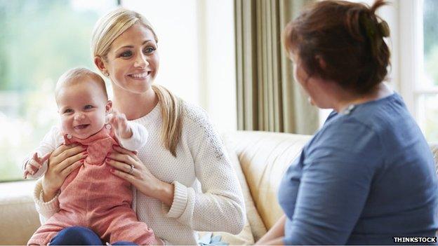 Health visitor with mother and baby