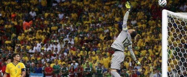 Brazil goalkeeper Julio Cesar tips over a Hector Herrera shot