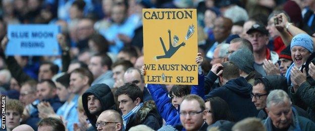 A Manchester City fan taunts Liverpool's Steven Gerrard during the title run-in