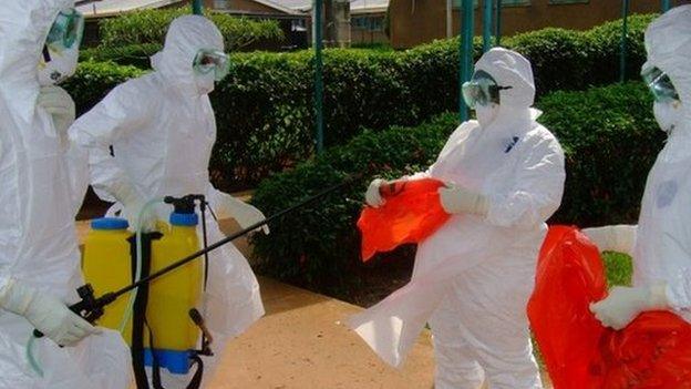 File photo of officials from the World Health Organization in protective clothing preparing to enter Kagadi Hospital in Kibale District, about 200 kilometres from Kampala, where an outbreak of Ebola virus started (28 July 2012)