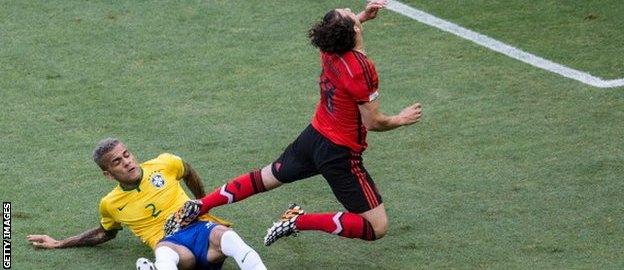 Brazil's Dani Alves challenges Mexico's Andres Guardado.