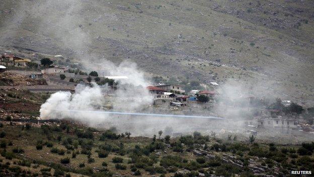 Smoke rises as police burn cannabis plants during a raid in the village of Lazarat 17 June 2014.