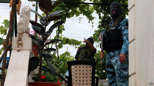 Albanian police comb houses in Lazarat village, 230 kilometres (140 miles) south of capital Tirana, on 17 June 2014