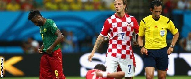 Alex Song of Cameroon walks off the field after receiving a red card