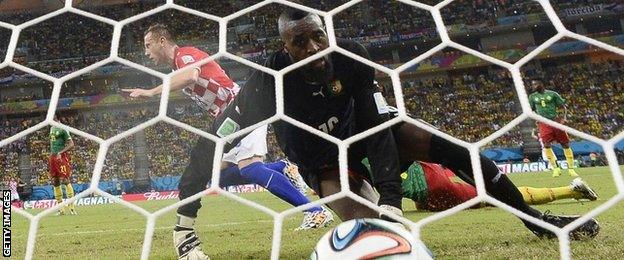 Cameroon's goalkeeper Charles Itandje looks at the ball after Croatia"s forward Ivica Olic scores