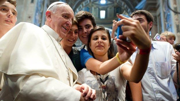 Pope Francis has his picture taken inside St. Peter's Basilica with youths from the Italian Diocese of Piacenza and Bobbio who came to Rome for a pilgrimage, at the Vatican, on Wednesday, 28 August 2013