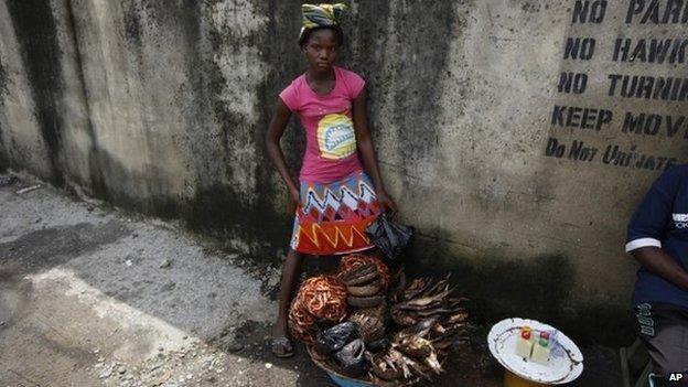 Twelve-year-old, Kemi Olajuwon, who has to drop out of school some days to sell smoked fish and make money in the Obalende area of Lagos, Nigeria, on June 17, 2014