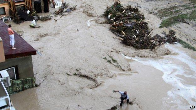 People try to protect themselves from floodwater in the Black sea town of Varna