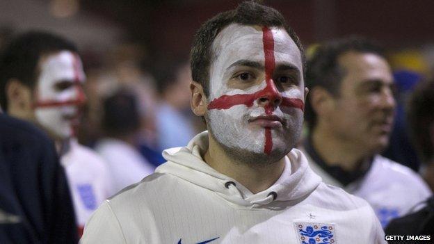A disappointed England fan leaves Arena de Sao Paulo stadium after the defeat against Uruguay (19 June 2014)