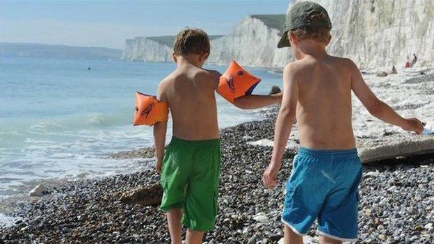 Two five-year old boys playing on a beach in East Sussex