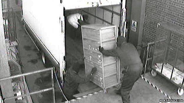 Police handout photo of CCTV footage of Britain's biggest cash robbery taking place at the Securitas depot in Tonbridge, Kent, in February 2006. Picture shows some of the men involved in the robbery loading cash a lorry in the loading bay of the depot.