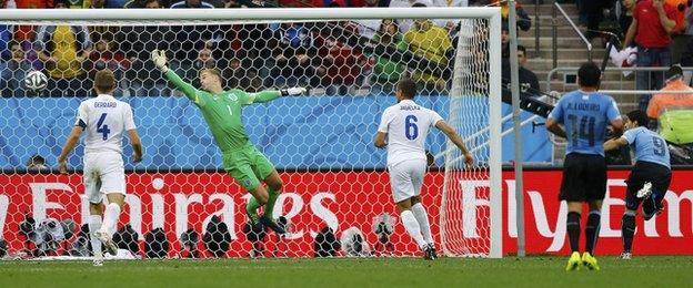 Uruguay striker Luis Suarez (right) scores the winner against England