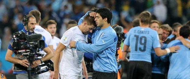 Uruguay striker Luis Suarez consoles England captain and Liverpool team-mate Steven Gerrard