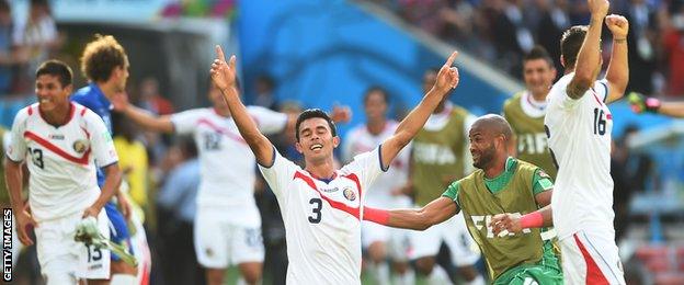 Costa Rica players celebrate after defeating Italy at the 2014 World Cup