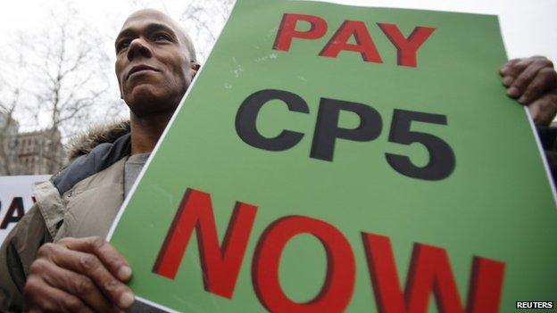 Desmond Cadogan holds up a sign during a rally in support of the Central Park Five in New York in this 17 January 2013