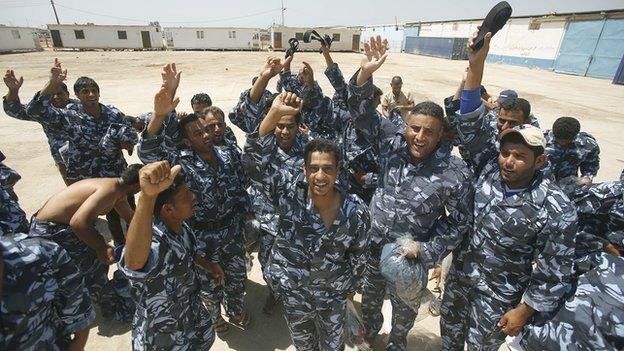 Iraqi volunteers wearing their new uniforms on 16 June 2014 in the central Shiite Muslim Shrine city of Karbala