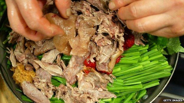 A chef prepares a meal using dog meat at a restaurant in South Korea - 5 July 2005