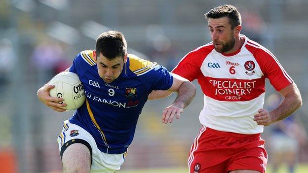 Longford's Kevin Diffley tries to burst away from Derry's Mark Craig at Celtic Park