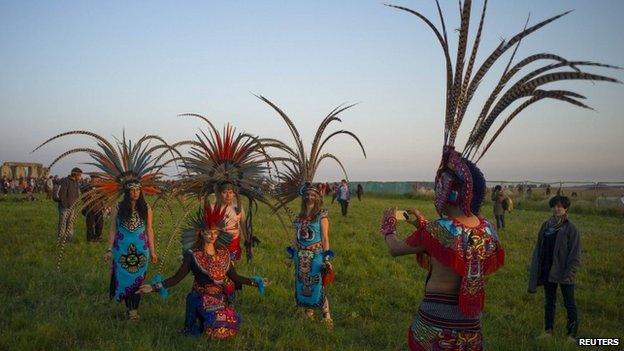 Revellers dressed in Aztec costume celebrate the summer solstice