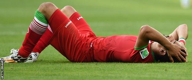 Iran defender Pejman Montazeri reacts at the final whistle after his team's 1-0 defeat to Argentina