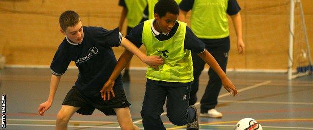 School children playing football