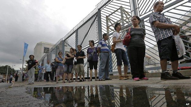 People queue up at a polling centre to vote in an unofficial referendum on democratic reform in Hong Kong on Sunday, 22 June, 2014