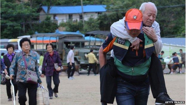 In this handout provided by the Hong Jin-Hwan-Donga Daily, residents evacuate from their homes to a shelter on 22 June 2014 after gunfire between South Korean soldiers and a soldier who is on the run after a shooting.