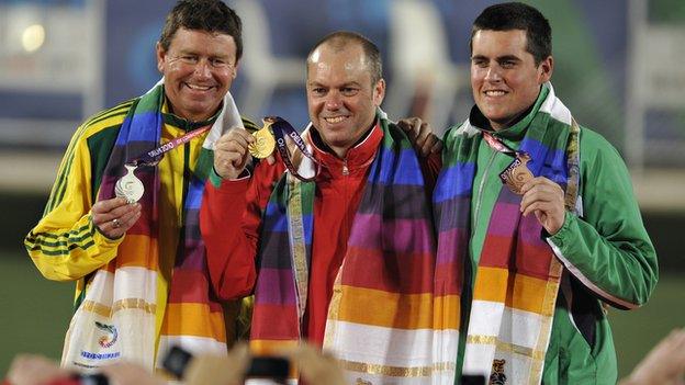 Australia's Leif Selby (C), Wales' Rob Weale (L) and Northern Ireland's Gary Kelly pose with their respective gold, silver and bronze medals during the men's lawn bowls singles awards...