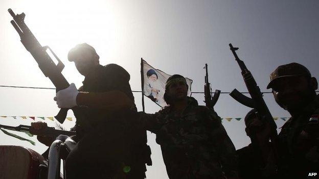 Iraqi Shia fighters parade with their weapons in Karbala