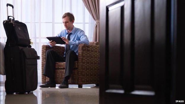 Businessman in hotel on tablet