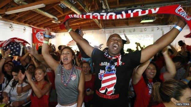 Fans cheer after USA scored the second goal during the 2014 World Cup Group G soccer match between Portugal and the US. at a viewing party in Los Angeles, California 22 June 2014