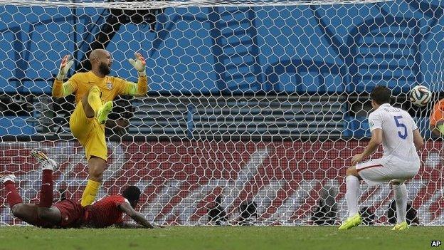 Portugal's Silvestre Varela watches as his header goes past United States goalkeeper Tim Howard to score his side's second goal and tie the game 2-2 during the group G World Cup soccer match between the USA and Portugal at the Arena da Amazonia in Manaus, Brazil 22 June 2014