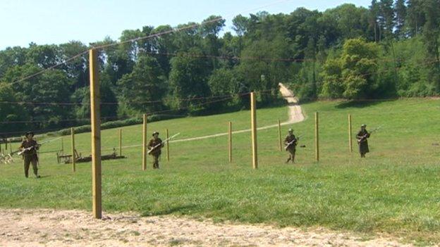 Soldiers in a field in the play Mametz