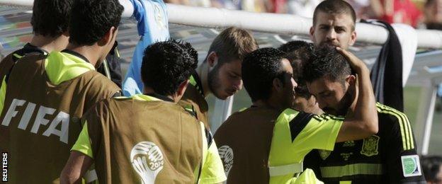 David Villa (far right) is consoled by his team-mates after coming off