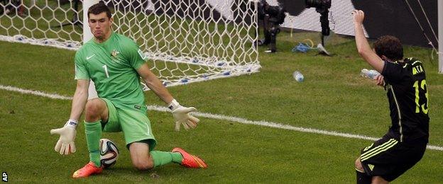 Juan Mata (right) slides in Spain's third