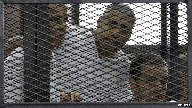 Peter Greste, Mohamed Fahmy and Baher Mohamed (L-R) listen to the ruling in court in Cairo - 23 June 2014