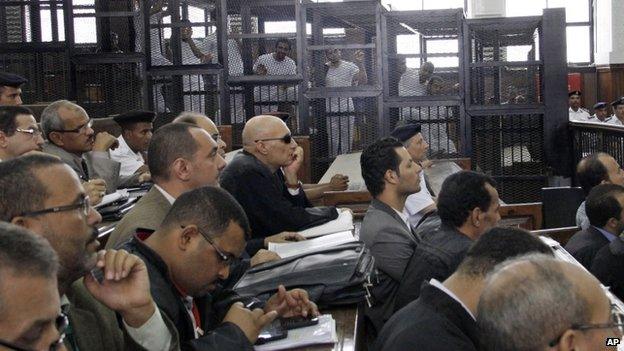 Lawyers attend the sentencing hearing for journalists working for Al-Jazeera in a courtroom in Cairo, Egypt