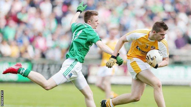 Antrim's Ricky Johnston tries to break clear of Fermanagh's Barry Owens in this year's Ulster SFC game at Enniskillen