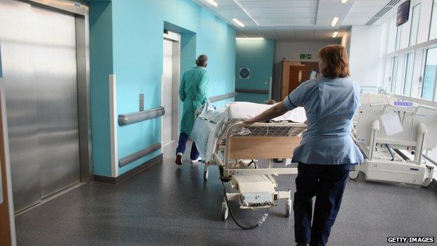 Nurses pushing a bed in an hospital