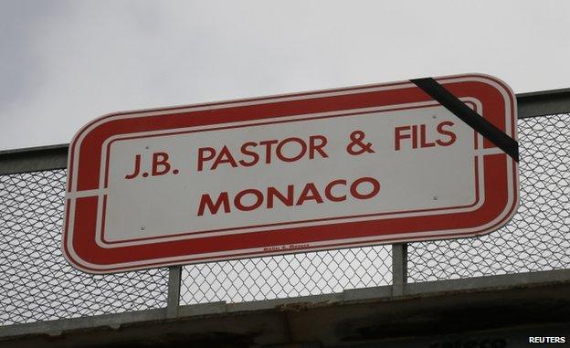 A black ribbon is seen on sign for the Pastor and Sons construction company in Monaco (22 May 2014)