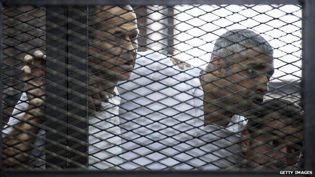 Al-Jazeera news channel's Australian journalist Peter Greste (left-right) and his colleagues, Mohamed Fadel Fahmy and Egyptian Baher Mohamed listen to the verdict on 23 June 2014